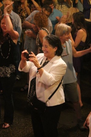Mayor Rogero takes a photograph in the rain of the Lonesome Coyotes, Bob Dylan Birthday Bash, Market Square, Knoxville, June 2013